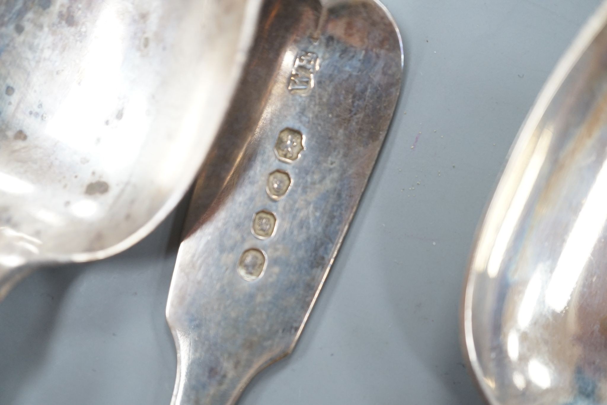 A set of six Victorian silver fiddle pattern dessert spoons, William Eaton, London, 1843, a set of six earlier silver teaspoons and a pair of George III silver sauce ladles, 14oz.